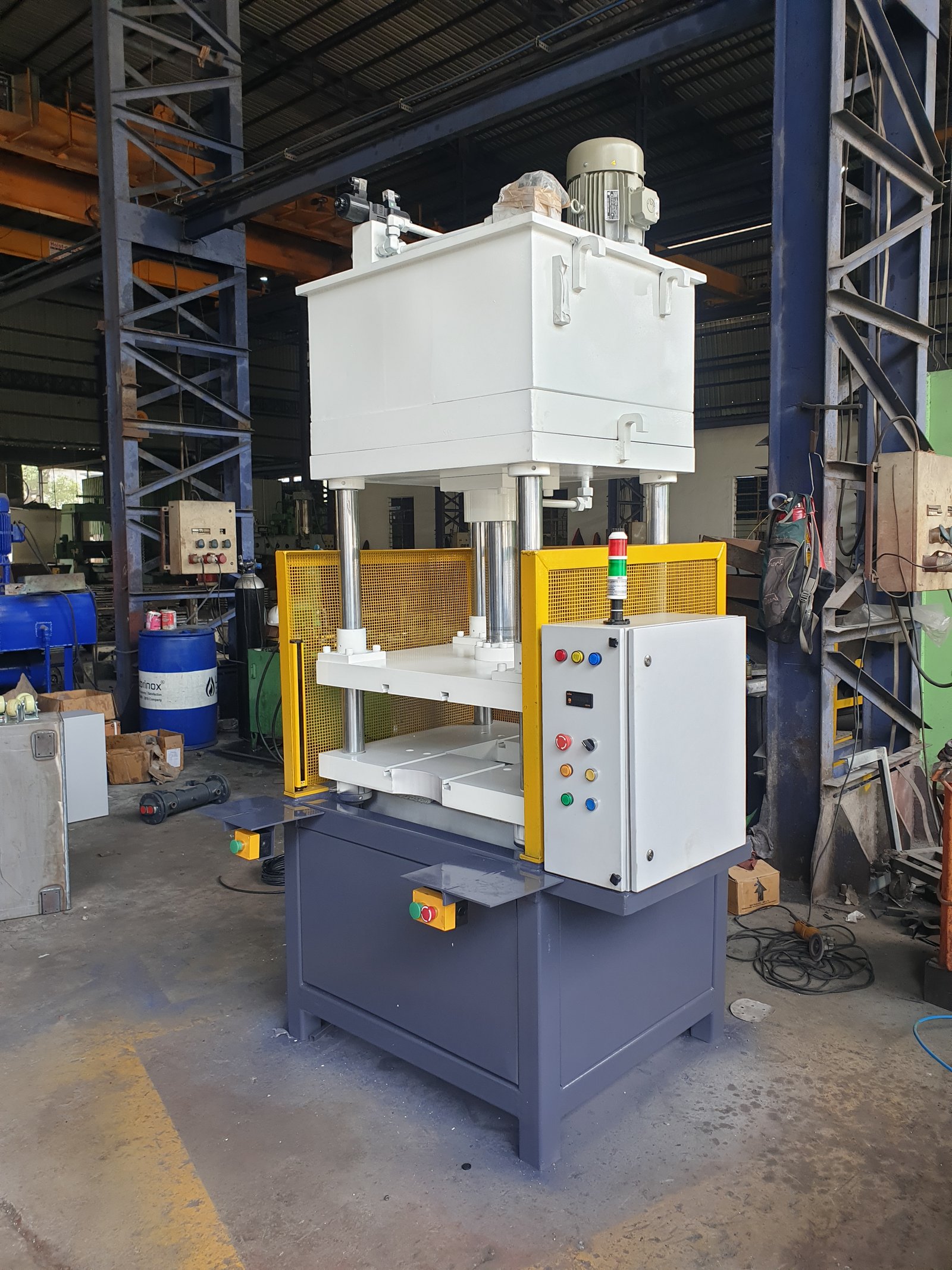 Four-Pillar Hydraulic Press with yellow mesh guards and pushbutton control panel, Pune manufacturer