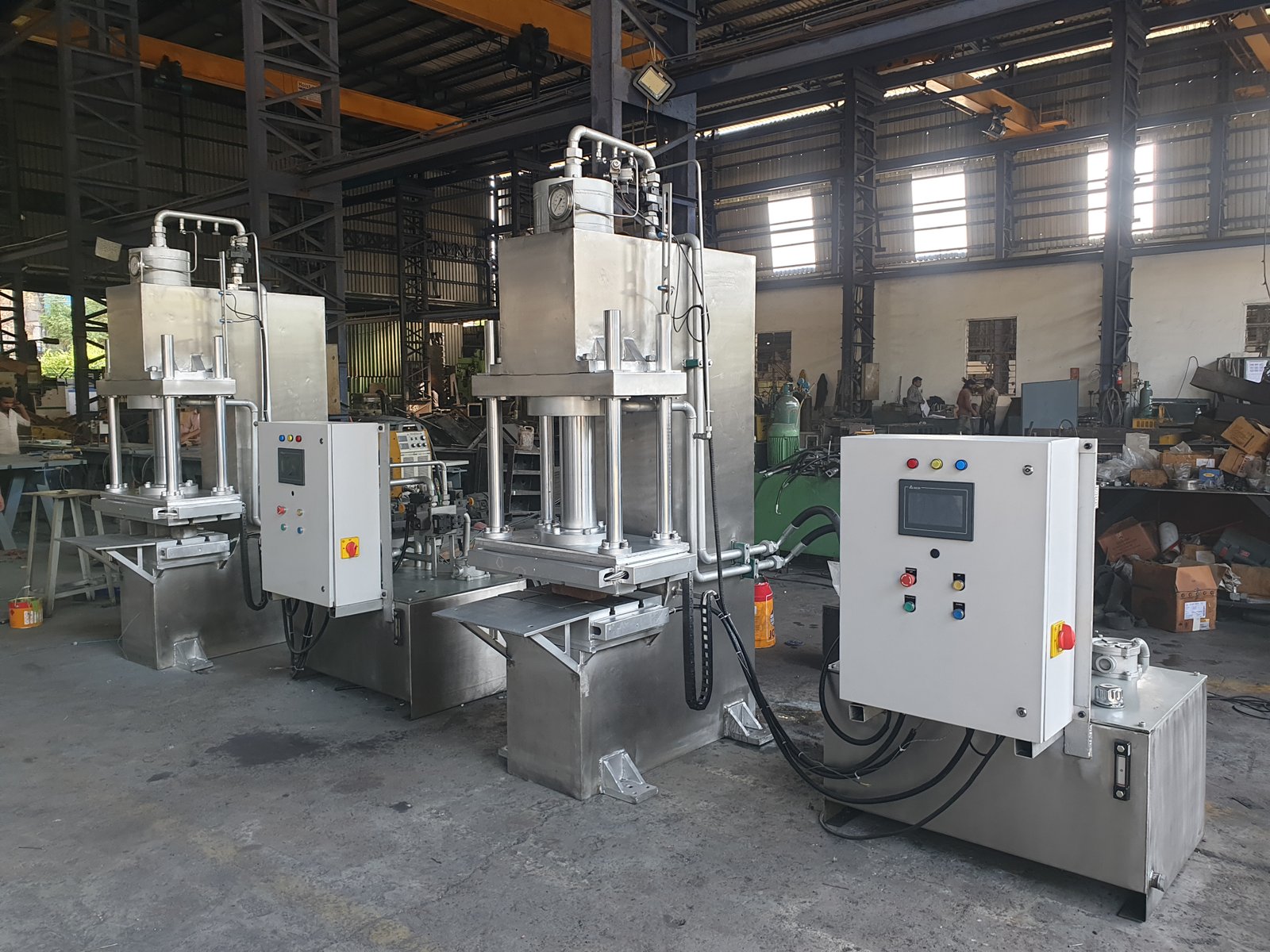 Two stainless steel Four-Pillar Hydraulic Presses with HMI panels, manufactured in Maharashtra