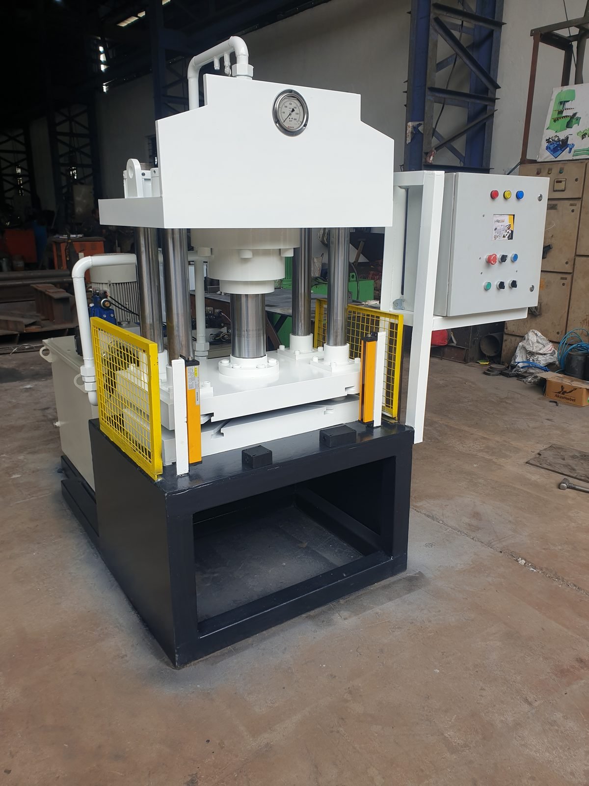 Finished Four-Pillar Hydraulic Press with yellow mesh guarding, Desire Hydraulics Pune