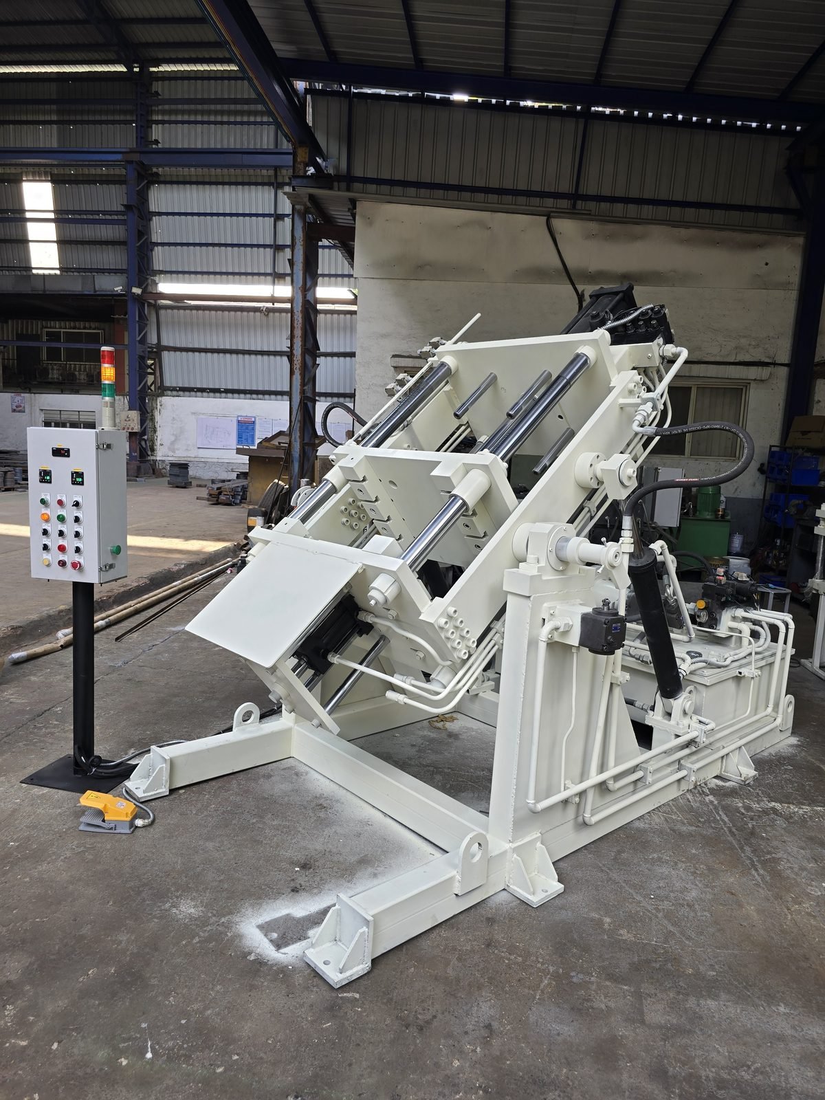 Four-Pillar GDC Tilting Machine shown tilted in pouring position, Desire Hydraulics Pune