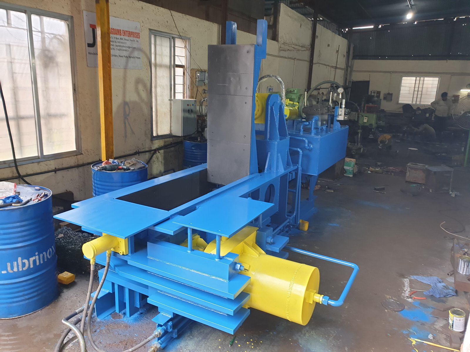 Blue Hydraulic Baler Machine with yellow compaction cylinder, manufactured by Desire Hydraulics, Pune