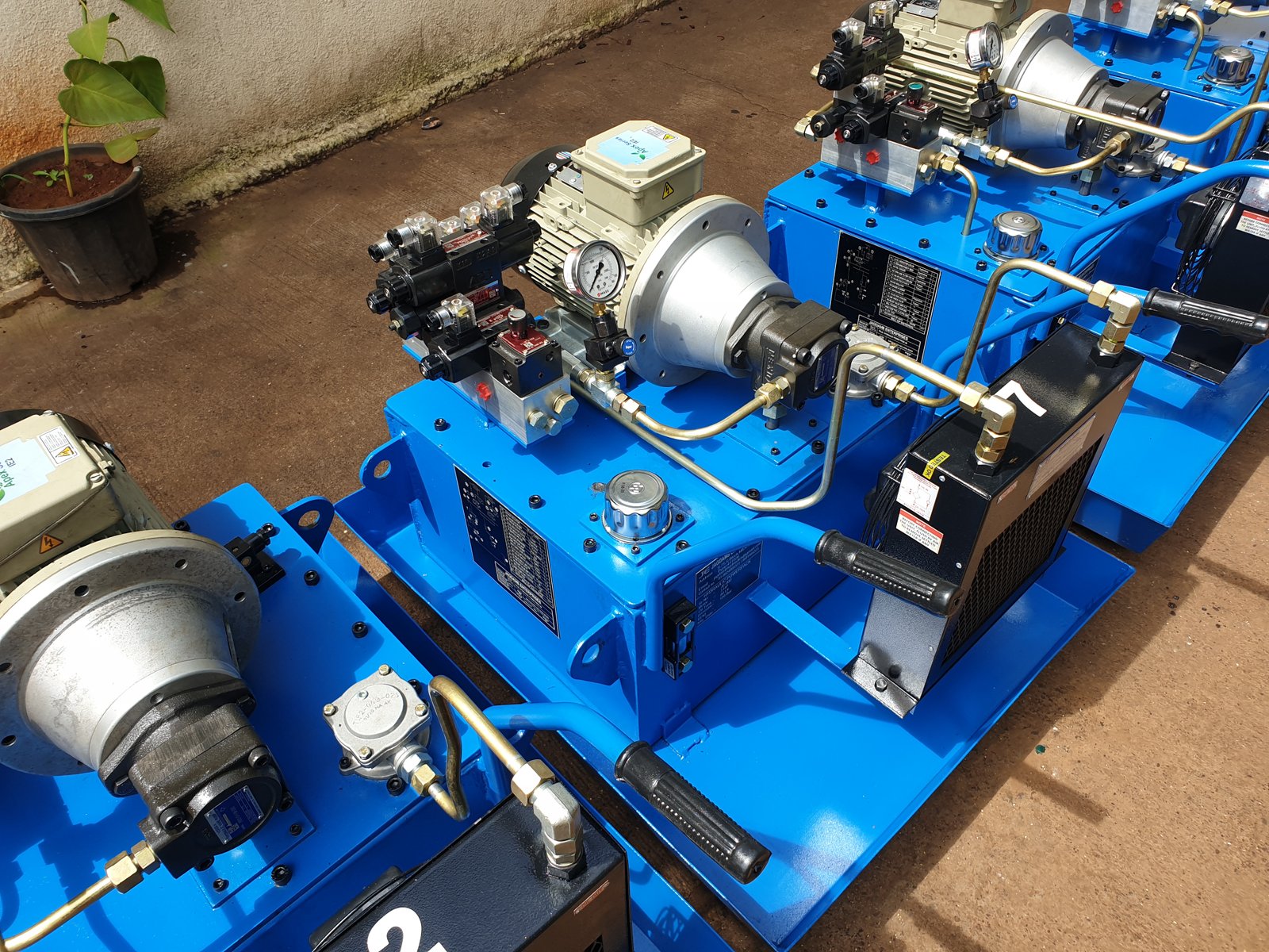 Blue Hydraulic Power Pack units on a production line, numbered and ready for dispatch, Pune