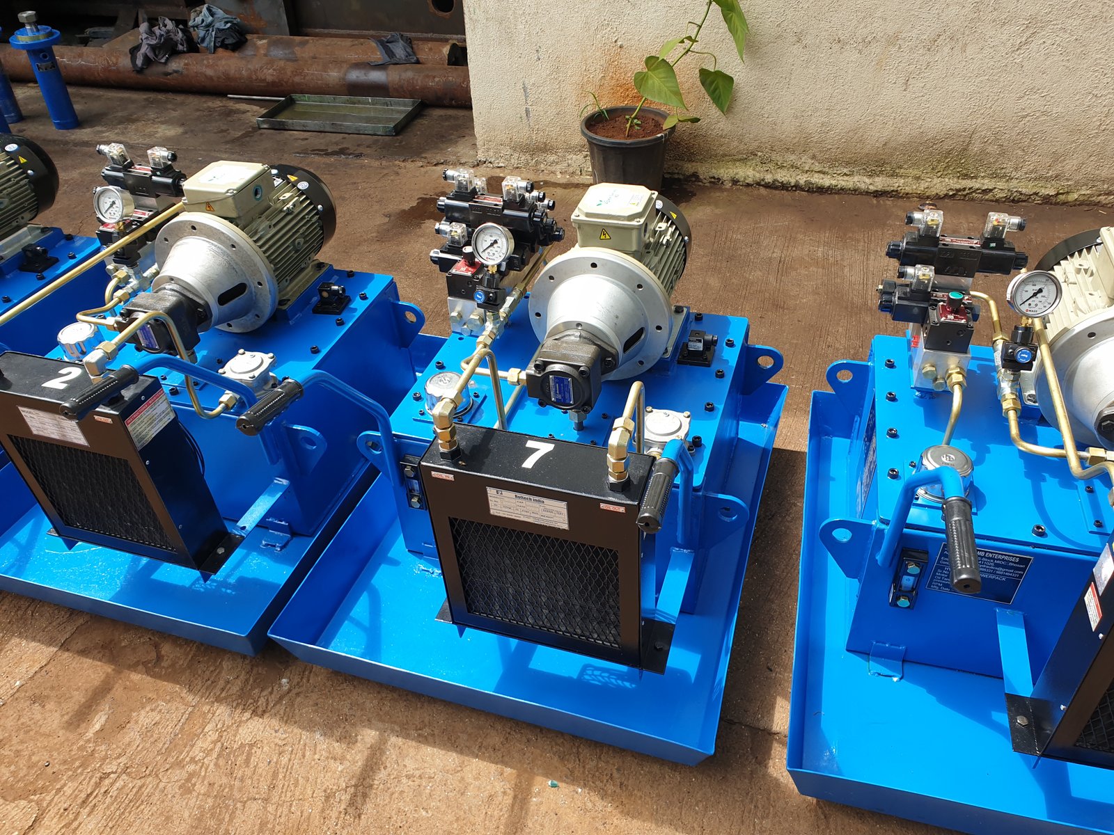 Multiple Hydraulic Power Pack units with oil coolers lined up on the shop floor, Desire Hydraulics Pune
