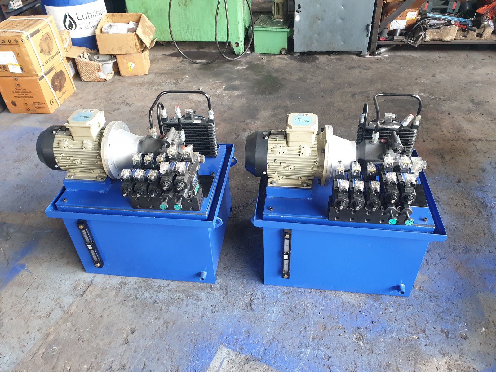 Two blue Hydraulic Power Pack units with black oil coolers, manufactured in Pune