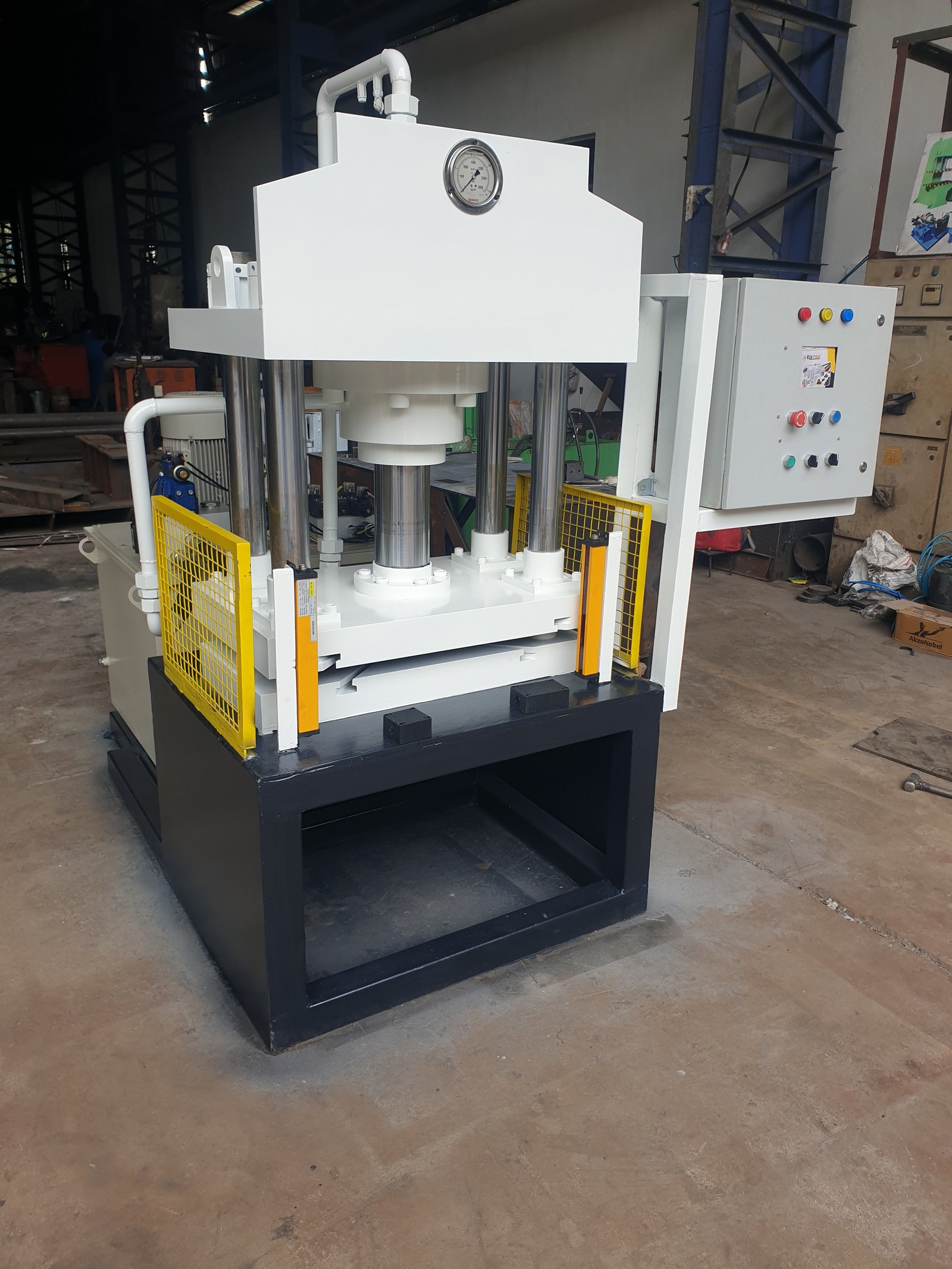 Hydraulic Press Machine on black base with yellow mesh guarding, Desire Hydraulics Pune
