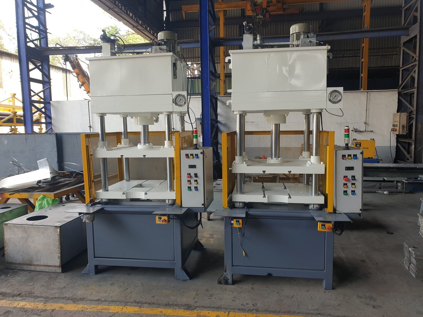 Twin hydraulic Trimming Press machines side by side with mesh guards, manufactured in Pune